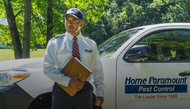 Home Paramount Pest Control technician spraying for pests